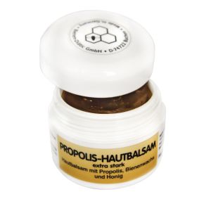 Brauner Propolis Hautbalsam in einer weißen Tiegeldose